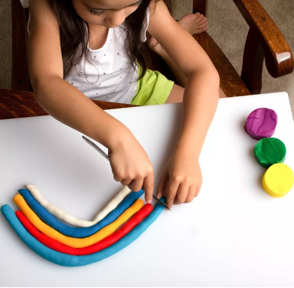 Girl playing with clay dough